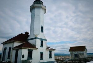 Washington State presents a stunning array of landscapes, featuring notable structures such as this lighthouse, alongside breathtaking waterfalls and lush forests.