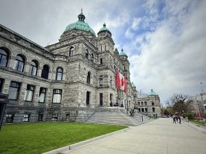 This image brings you to the iconic Houses of Parliament where a Canadian Flag has been carefully raised.
