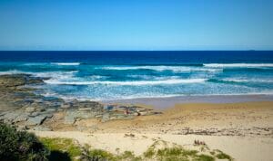 Imagine standing on the exotic Queensland coastline, gazing out over the Pacific Ocean, as depicted in this image.