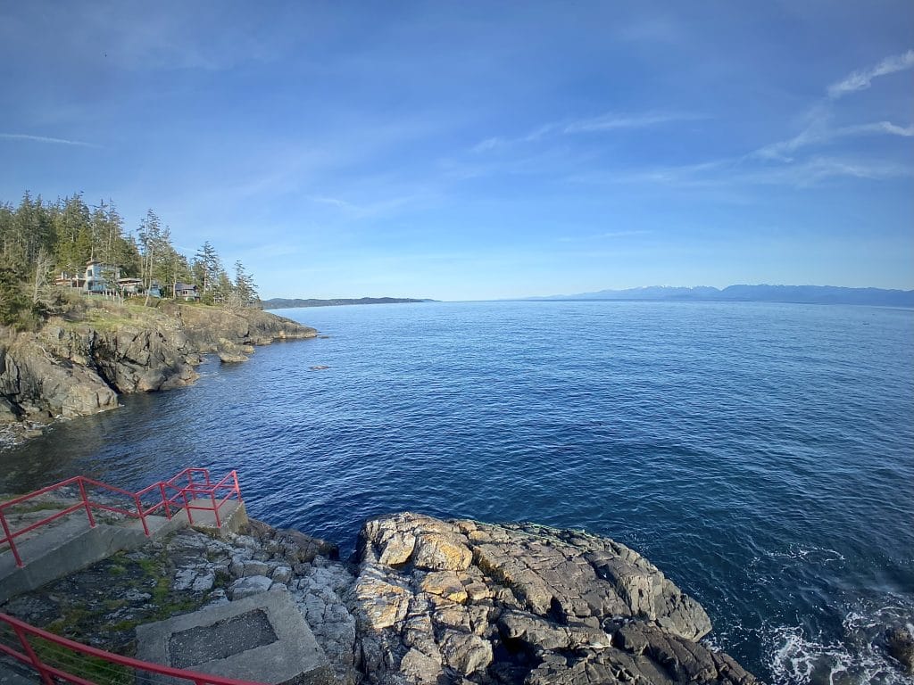 Standing at this vista you look ahead to jagged coast and blue horizons.