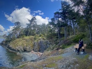 In this coastal paradise amidst forest and ocean a person is seen reading a book. Sooke offers serene places to enjoy reading while being grounded in the moment.