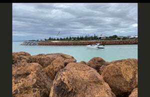 Ocean life converges and is invigorated by the sea breeze. This scene reveals a canal set against the backdrop of rocky terrain.